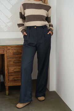 NAZ Mara Trousers in Navy. Made with 100% wool. Produced ethically in Portugal. Paired with the Mia Striped Sweater in Beige.