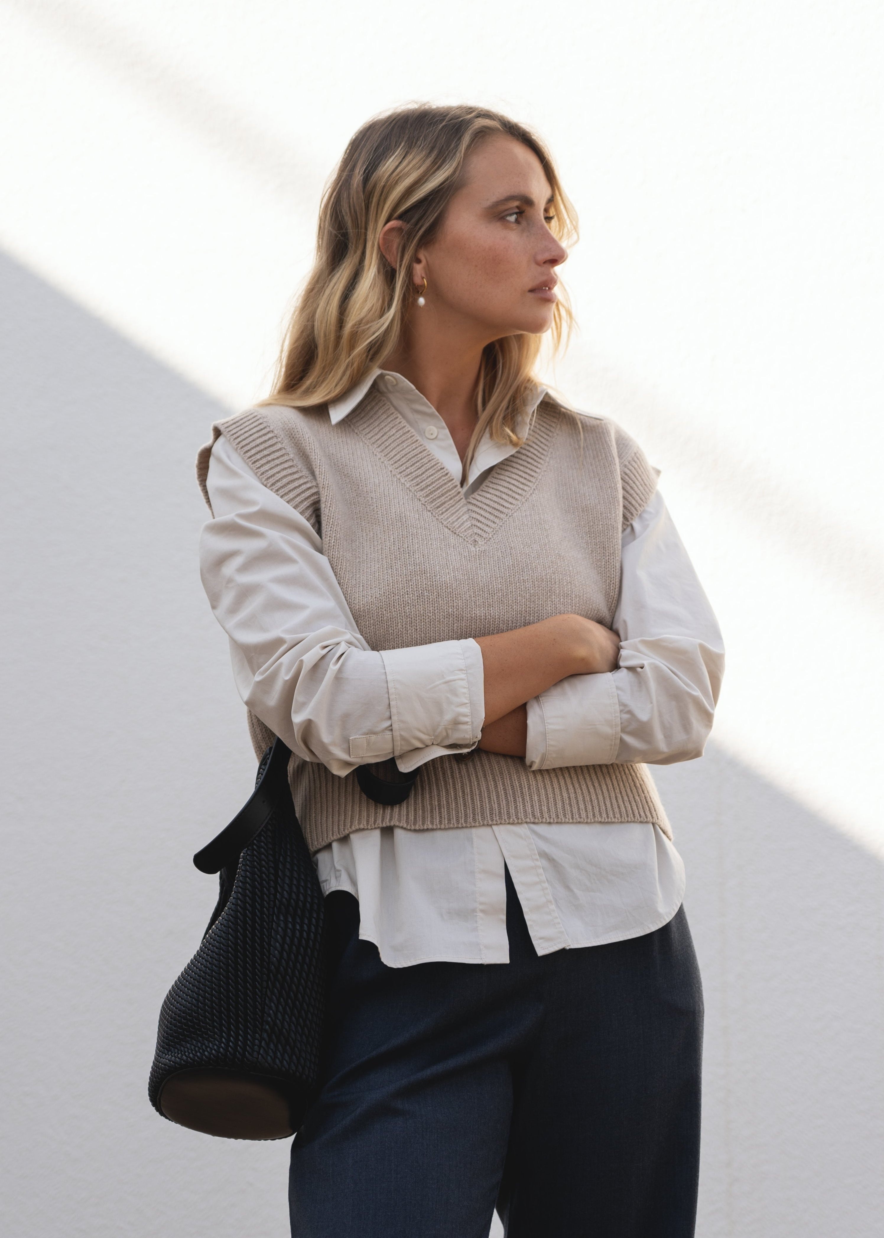 NAZ Alice Knit Vest in Beige. Made with 100% Recycled Wool. Paired with the Mara Wool Trousers in Navy.