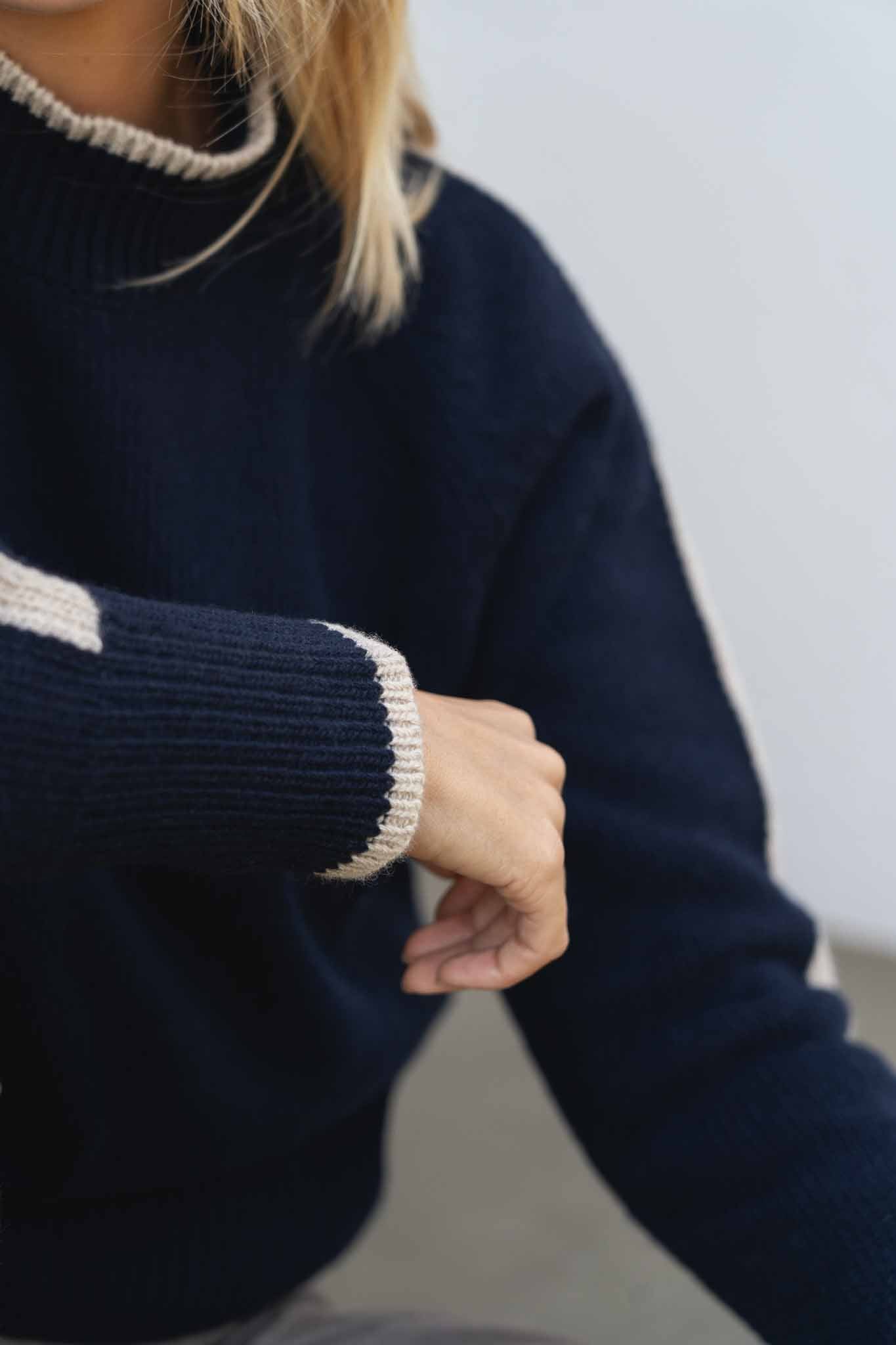 NAZ Agnes Sweater in Navy. Featuring a Beige color block detail. Made with 100% Recycled Wool.